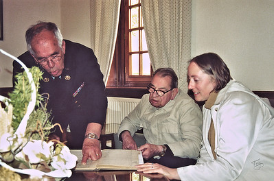 Brittany American Cemetery 2004 Memorial Day - Arsenault goes over the post-war logbooks with Dad as Judy looks on.